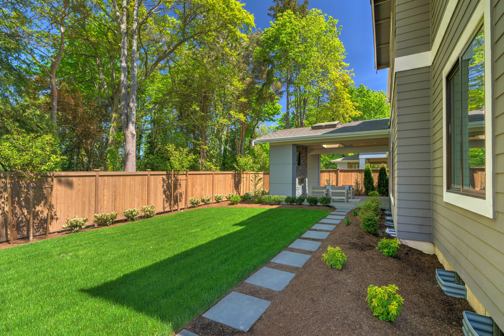 exterior of home with fresh mulch and green grass 